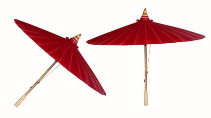 The red umbrella is placed on the floor, two leaves behind, causing the background to be white.