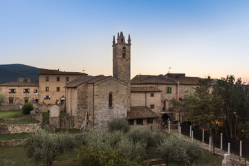 Santa Maria Church, in Monteriggioni, Italy, at dusk