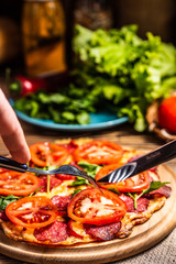 Pizza with cheese, tomatoes and salami