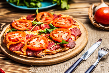 Pizza with cheese, tomatoes and salami