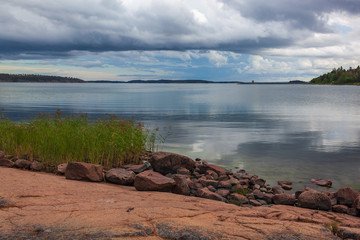 Scenic stony seashore of the Aland Islands at midsummer before a rain, Finland
