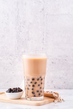 Popular Taiwan Drink - Bubble Milk Tea With Tapioca Pearl Ball In Drinking Glass On Marble White Table Wooden Tray Background, Close Up, Copy Space