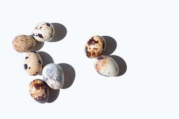 Fresh quail eggs over white background. Copy space
