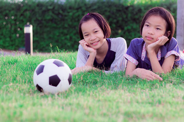 Obraz premium Happy funny sisters twins child. asian little girl in park at thailand