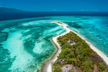 Naklejka na ściany i meble Truly amazing tropical island in the middle of the ocean. Aerial view of an island with white sand beaches and beautiful lagoons