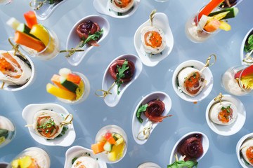 Fresh snacks fish meat, tuna, with greens on the table in restaurant. Top view. 