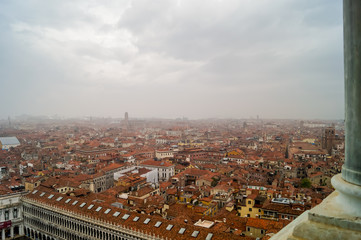 Fototapeta na wymiar Beautiful aerial view of the red rooftops in an Italian city during a foggy day