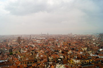 Beautiful aerial view of the red rooftops in an Italian city during a foggy day