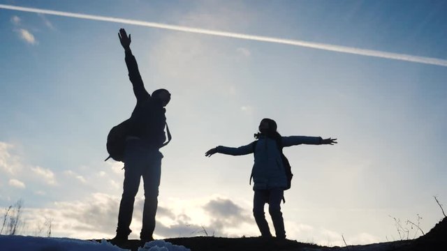 happy family dad with daughter teamwork tourists silhouette concept. slow motion video. dad and daughter with backpacks show hand gesture plane journey airplane. man and young happiness girl lifestyle