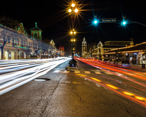 Long Exposure of Passing Traffic During Christmas. Light Trails of Cars. Christmas Decorations at Night. Festive Lights.