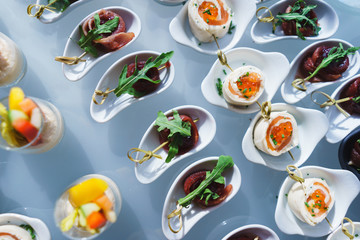 Fresh snacks fish meat, tuna, with greens on the table in restaurant. Top view. 