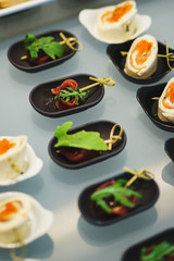 Fresh snacks fish meat, tuna, with greens on the table in restaurant. Top view. 
