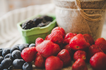 fresh strawberry blueberry and blackberry on wooden desk