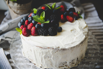 beautiful white cream cheese cake with different summer berries