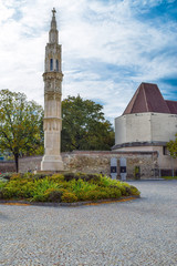 Fototapeta premium Abandoned street in smal town in Vienna Austria with blue sky and catholic church and paving stone