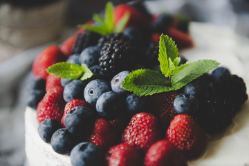 beautiful white cream cheese cake with different summer berries