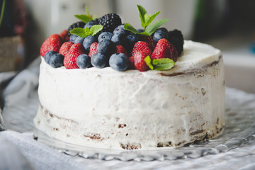 beautiful white cream cheese cake with different summer berries