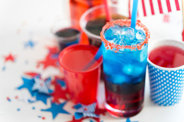 celebration, anniversary and national holidays concept - close up of drinks in cups and glasses on table at american independence day party