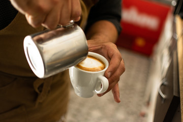 Fototapeta na wymiar Man doing and taking coffee from espresso machine