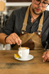 Man doing and taking coffee from espresso machine