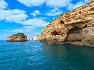 Fototapeta na wymiar Beautiful cliffs and caves in blue ocean in Albufeira at the Algarve coast of Portugal