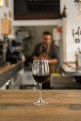 Wine glass filled with red wine on table in pub