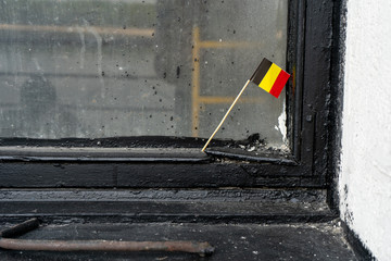 Flag of Belgium on the background of the glazed window frame. 