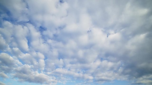 running clouds over blue sky