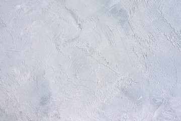 Gray textured concrete background. Empty grey backdrop with rough cement surface. Scratched concrete wall. Decorative plaster with grunge surface. Blank gray damaged backdrop. Closeup, selective focus