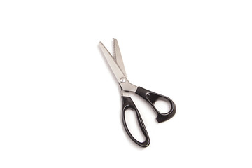 Pair of sewing scissors on white background