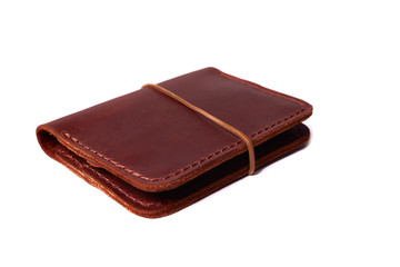 Handmade red color leather cardholder with rubber band isolated on white background closeup. Stock photo of handmade luxury accessories.