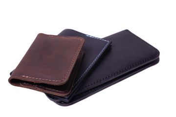 Handmade brown cardholder, black passport cover and purse isolated on white background closeup. Stock photo of handmade luxury accessories.