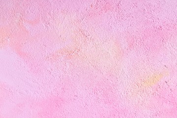 Pink decorative plaster background. Empty pink textured backdrop with rough surface. Scratched pink concrete wall with yellow spots. Decorative plaster with grunge surface. Blank pink backdrop.
