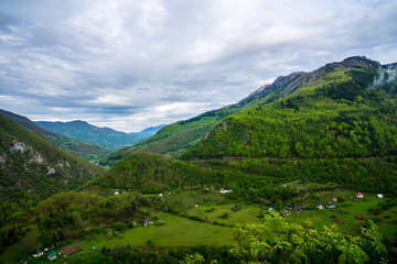 Obraz premium Montenegro, Wide view over green nature and forested landscape of mountains and valley of tara canyon from above