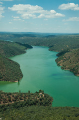 Tagus River running through a hilly valley with trees and house