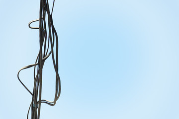 A bunch of electrical wires hanging on blue background