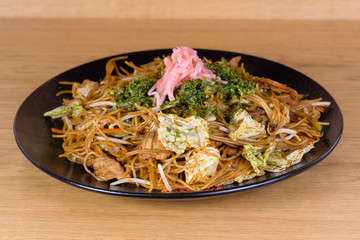 soy spaghetti with chicken and  vegetables, served on a decorated plate