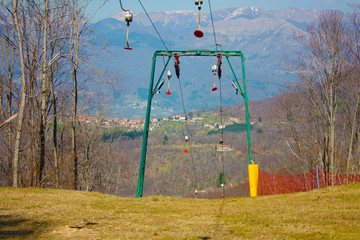 Fototapeta na wymiar ski lift or skilift. cable car pole on snow slope in summer.