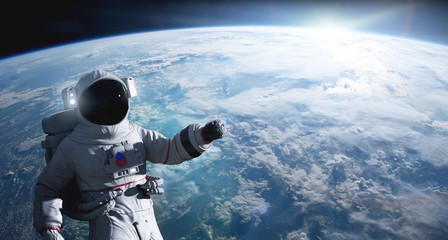 Astronaut conducting spacewalk on Earth orbit. © Photocreo Bednarek
