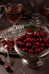 Vintage still life with ripe cherry and pewter