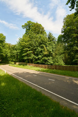 Two-lane country road through green landscape
