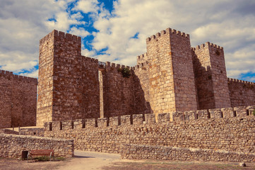 Towers and stone walls facade at the Castle of Trujillo