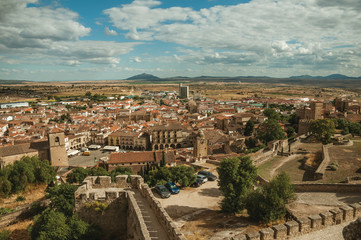 Fototapeta na wymiar Landscape with old buildings, rooftops and steeple at Trujillo