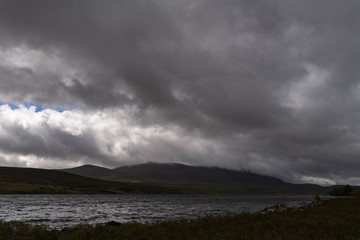 Low cloud and approaching rain covering Ben Klibreck on the shores of Loch Naver in Sutherland,...