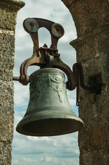 Fototapeta premium Bronze bell with details carved on the surface at the Castle of Trujillo