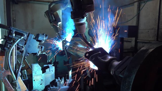 Welding robots movement in a car factory, automotive parts industry.