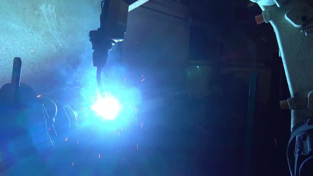 Welding robots movement in a car factory, automotive parts industry.