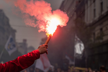 Man holding flaming torch during protest - obrazy, fototapety, plakaty
