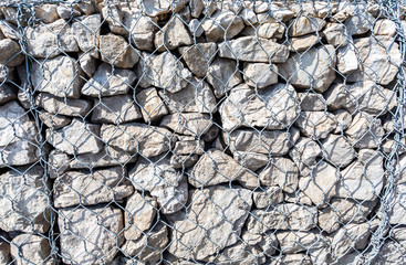 Stone wall with metal grid as background texture
