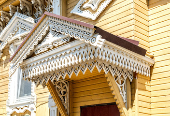 Fototapeta na wymiar Facade of an old house decorated with wooden carvings